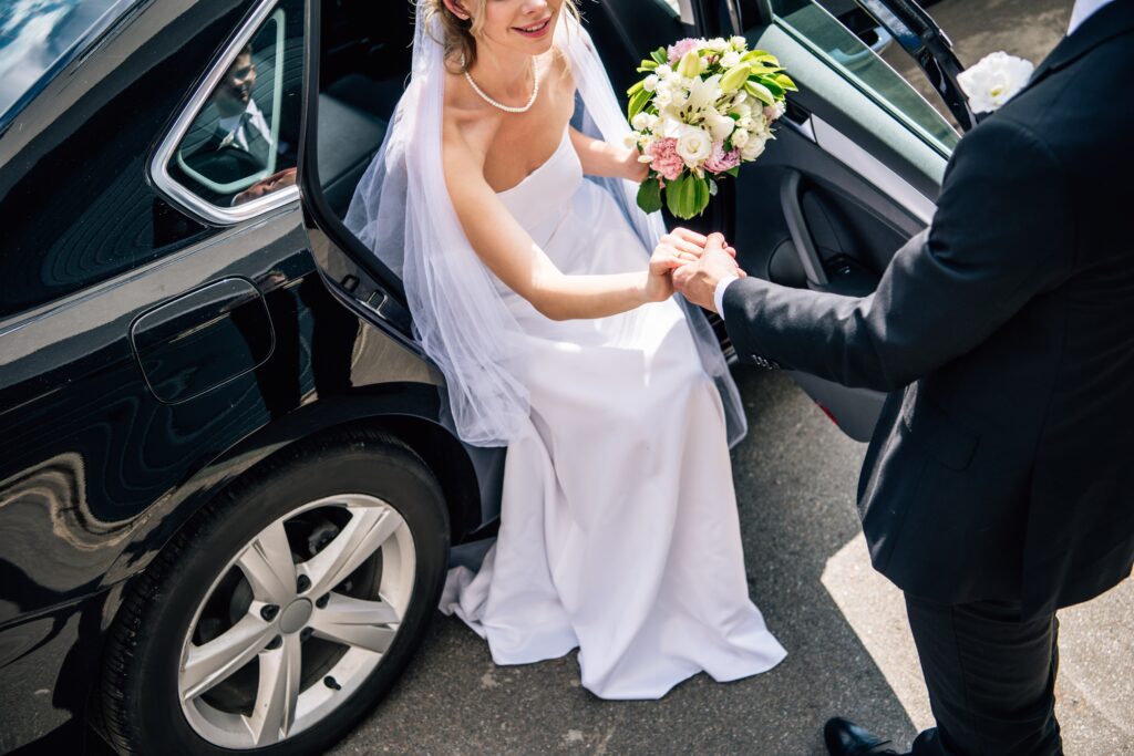Lake Travis Limo Wedding car servcie bridegroom in suit giving to groom